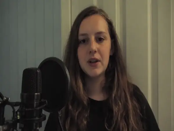 A person speaks beside recording equipment in a vertical video.